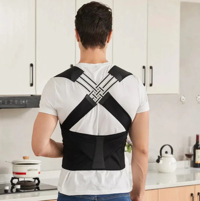 Person wearing a black posture corrector in a kitchen.